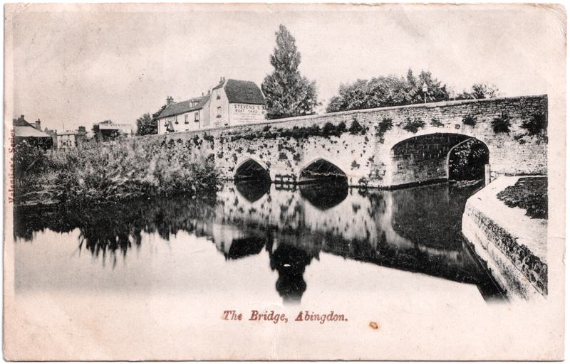 The front of an old postcard. The postcard is of Abingdon: The Bridge