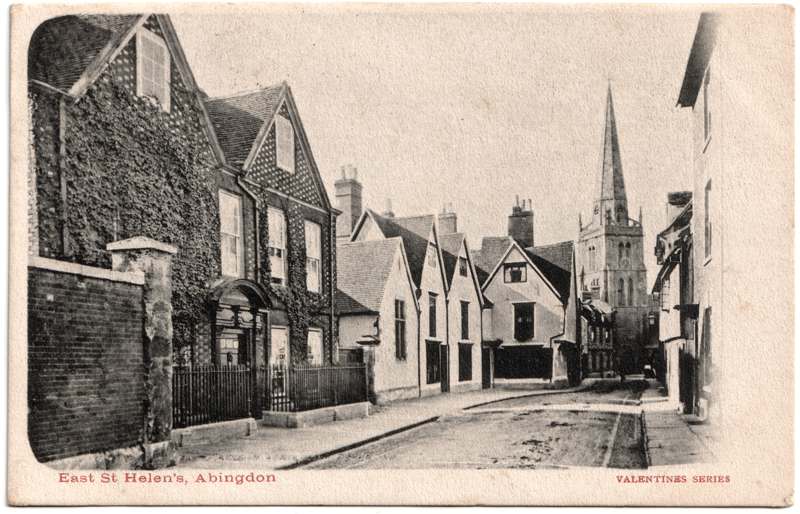 The front of an old postcard. The postcard is of Abingdon: Town Centre Streets
