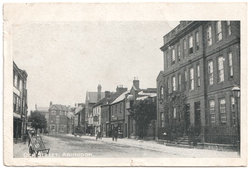 The front of an old postcard. The postcard is of Abingdon: Town Centre Streets