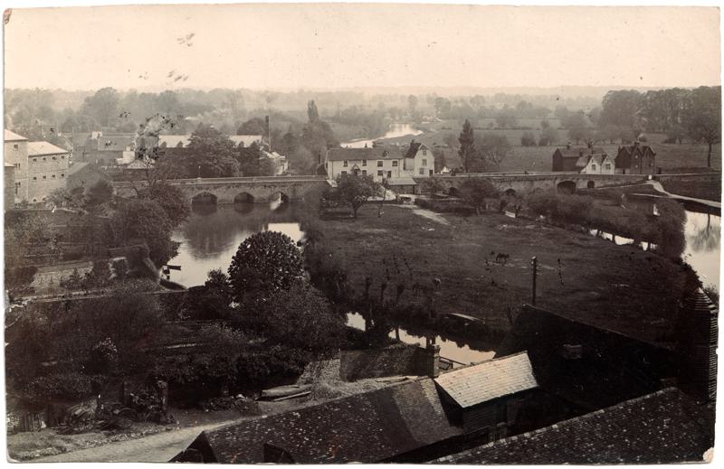 The front of an old postcard. The postcard is of Abingdon: The Bridge