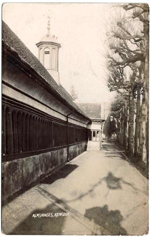 The front of an old postcard. The postcard is of Abingdon: St. Helen's Church and the Almshouses