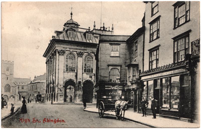 The front of an old postcard. The postcard is of Abingdon: Town Centre Streets