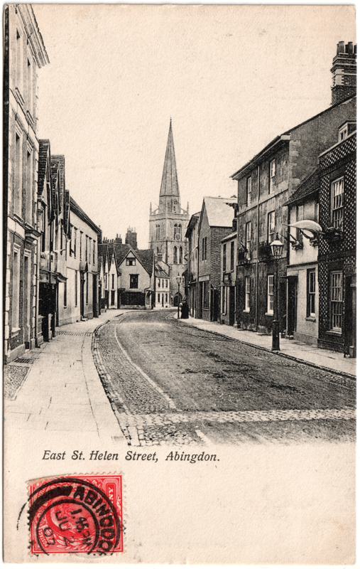 The front of an old postcard. The postcard is of Abingdon: Town Centre Streets