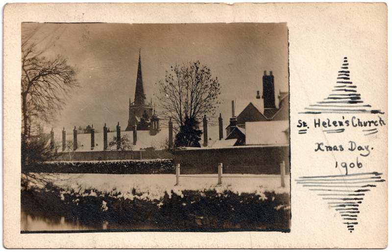 The front of an old postcard. The postcard is of Abingdon: St. Helen's Church and the Almshouses
