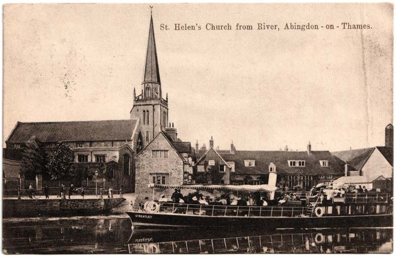The front of an old postcard. The postcard is of Abingdon: St. Helen's Church and the Almshouses