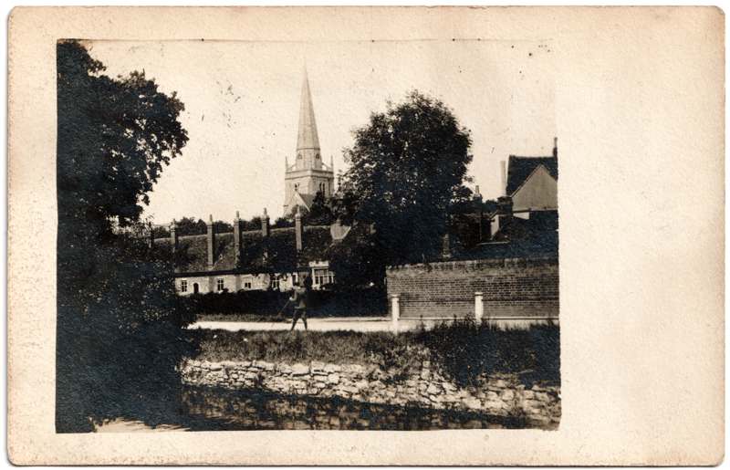 The front of an old postcard. The postcard is of Abingdon: St. Helen's Church and the Almshouses
