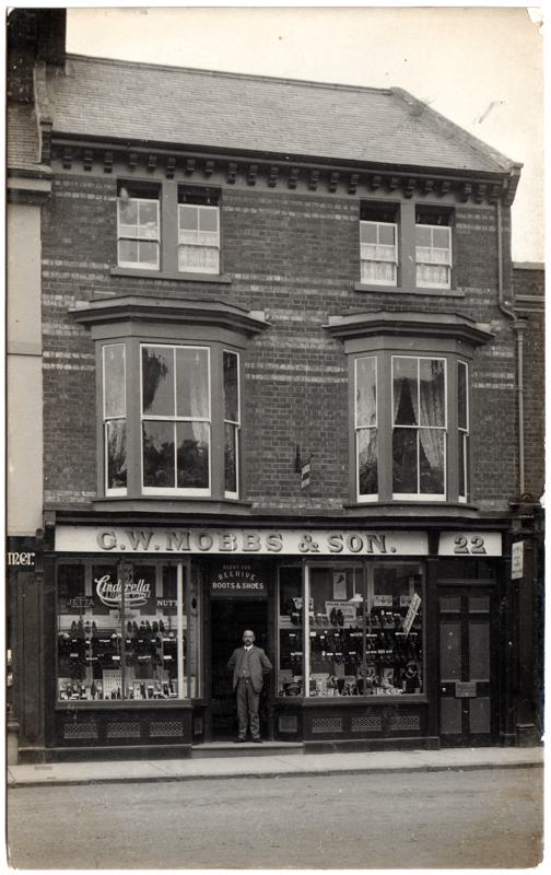 The front of an old postcard. The postcard is of Abingdon: Town Centre Streets