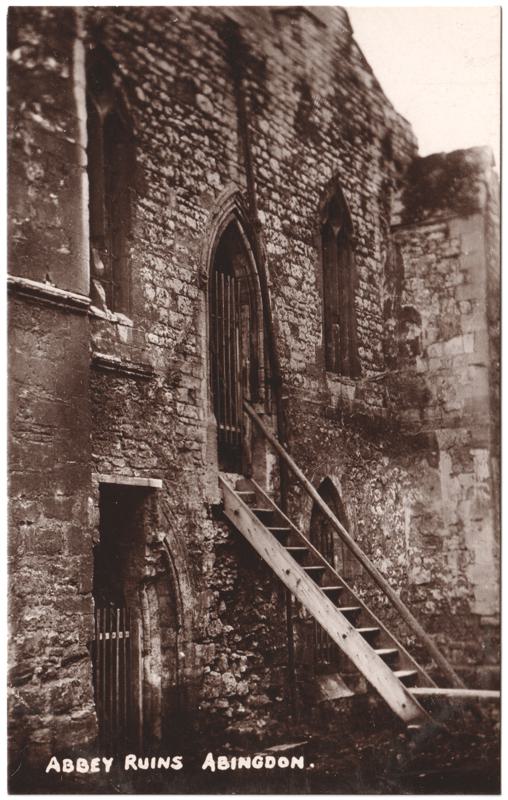 The front of an old postcard. The postcard is of Abingdon: The Abbey Buildings