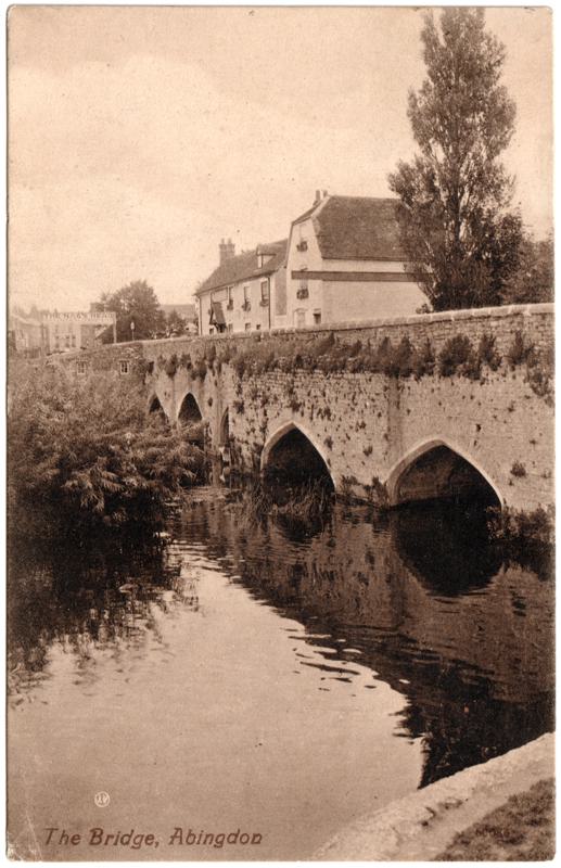 The front of an old postcard. The postcard is of Abingdon: The Bridge