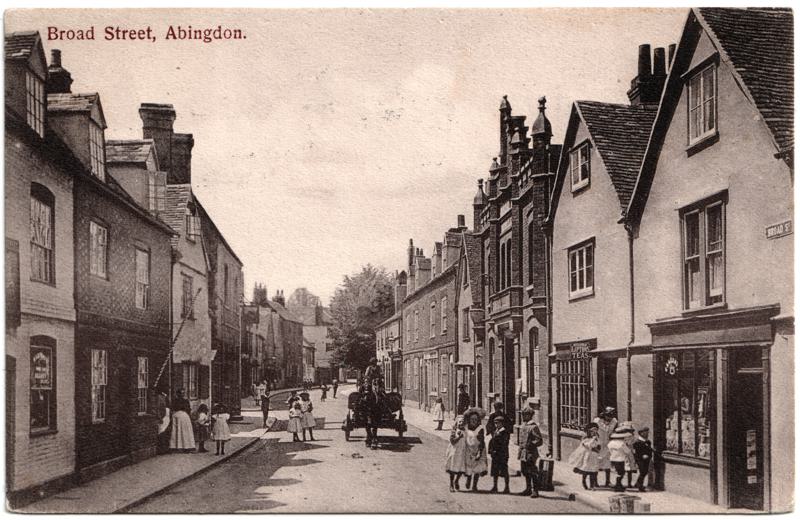 The front of an old postcard. The postcard is of Abingdon: Town Centre Streets