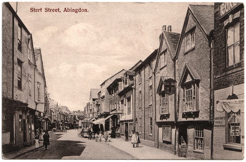 The front of an old postcard. The postcard is of Abingdon: Town Centre Streets