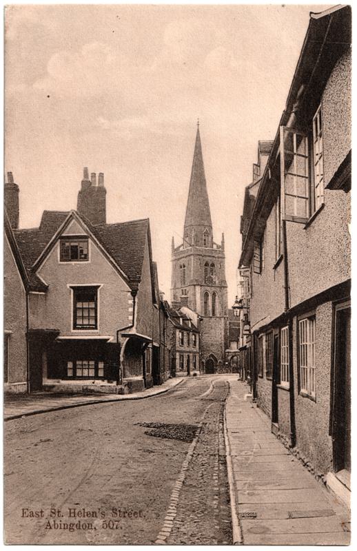 The front of an old postcard. The postcard is of Abingdon: Town Centre Streets