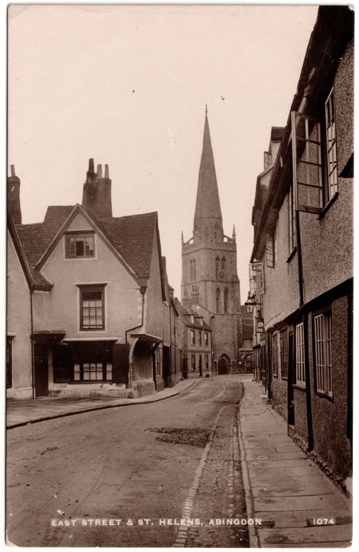 The front of an old postcard. The postcard is of Abingdon: Town Centre Streets