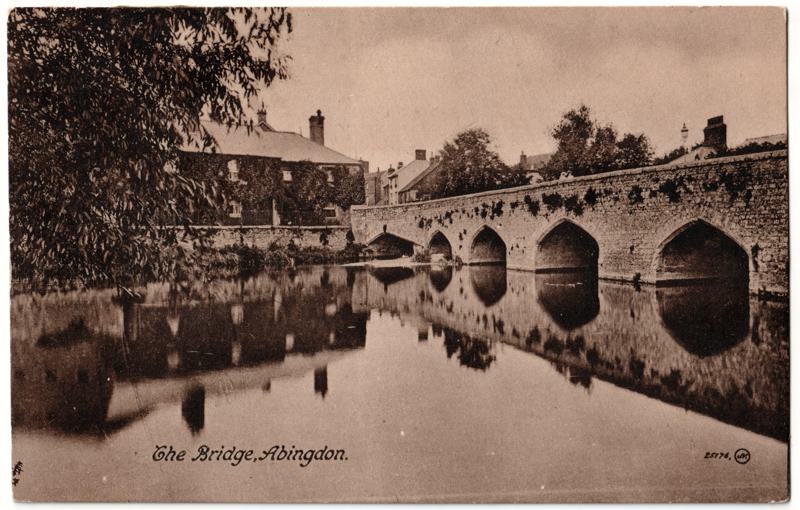 The front of an old postcard. The postcard is of Abingdon: The Bridge