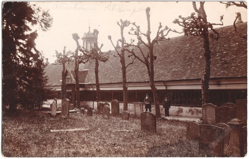 The front of an old postcard. The postcard is of Abingdon: St. Helen's Church and the Almshouses